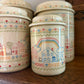Set of 4 Home Sweet Home Ceramic Canisters w/ Cross-stitch pattern
